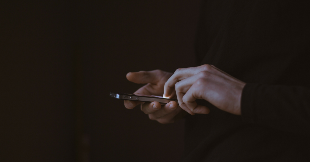 man-looking-at-cell-phone