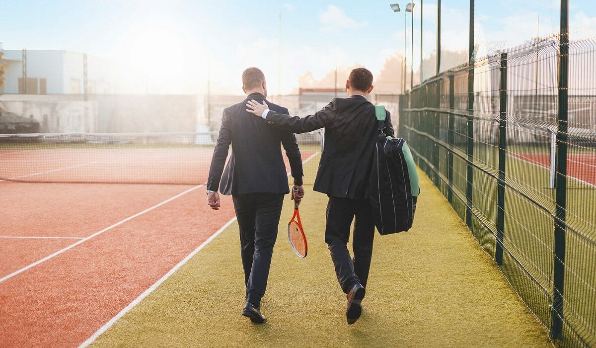 Business-men-with-tennis-racket-resized Business-men-with-tennis-racket-resized