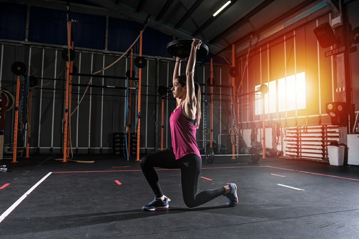 woman-split-lunging-with-weight-overhead