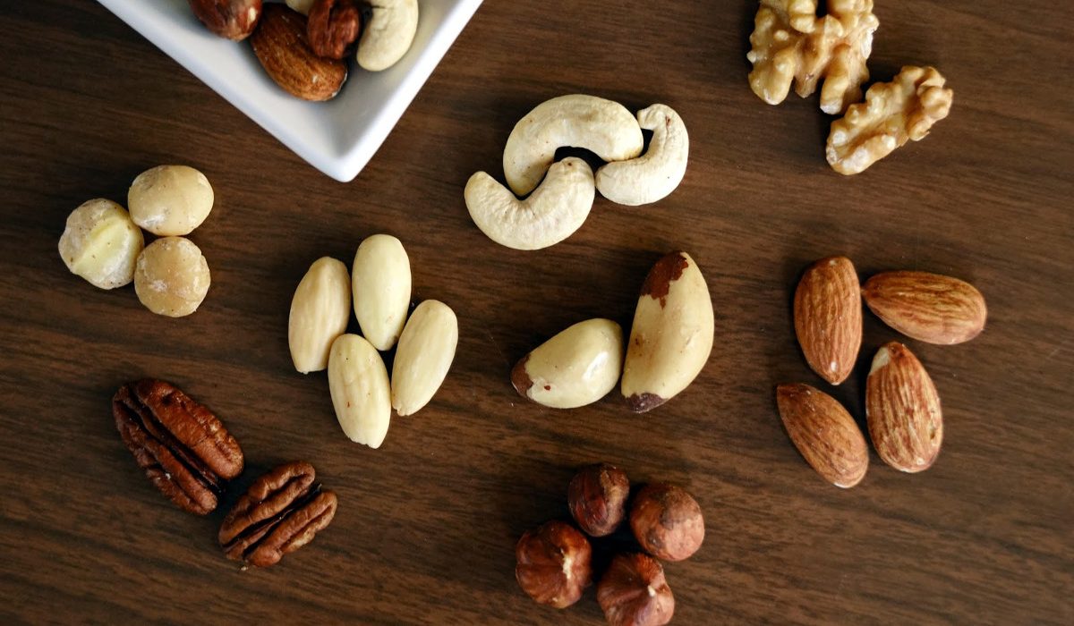 variety of brown nuts on brown wooden panel high angle photo 1295572