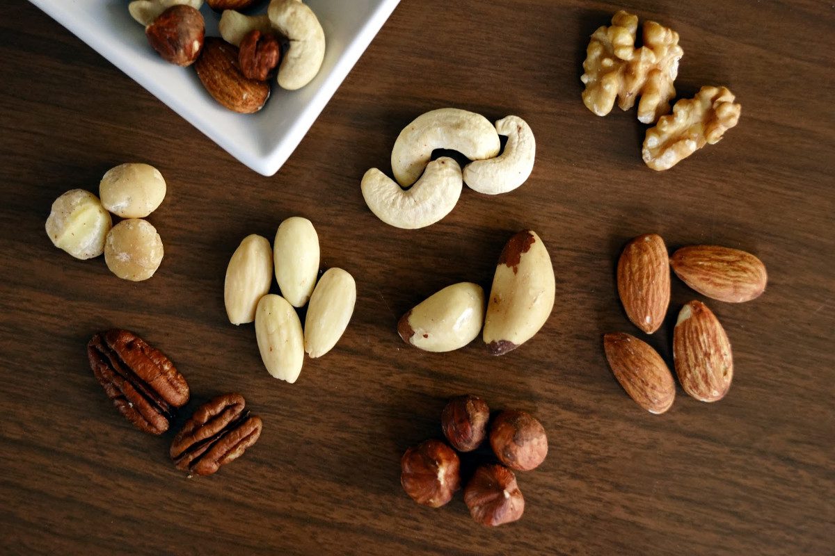 variety of brown nuts on brown wooden panel high angle photo 1295572