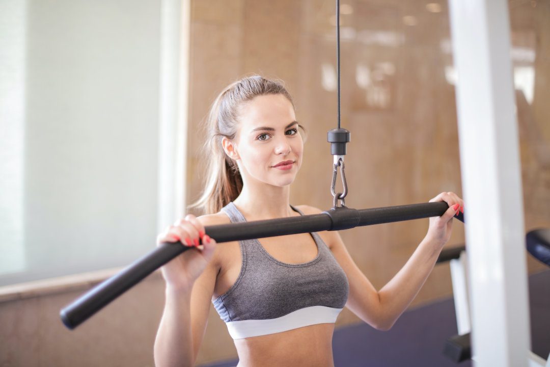 photo of woman performing lat pulldown