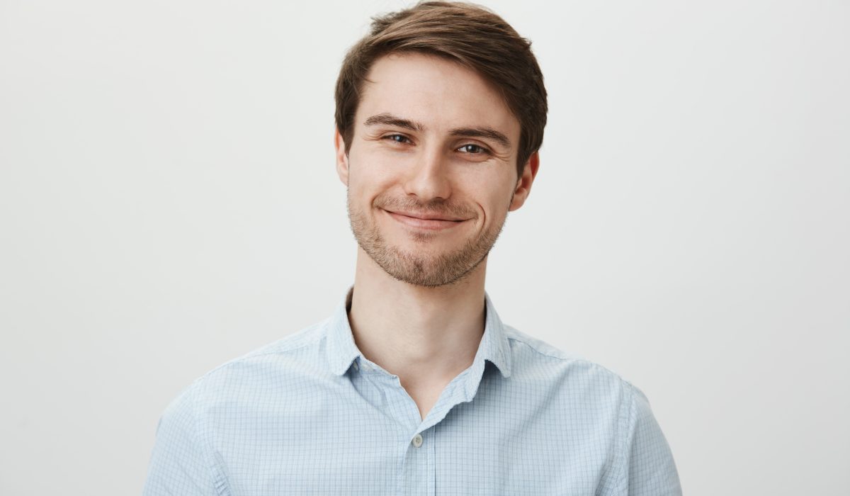 cute smiling young man with bristle looking satisfied min